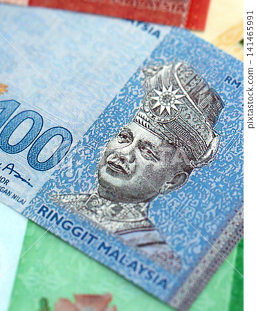 Malaysian ringgit paper banknotes pile on table. Malaysia MYR currency money bills in big amount Malaysian ringgit paper banknotes pile on table. Malaysia MYR currency money bills in big amount 141465991