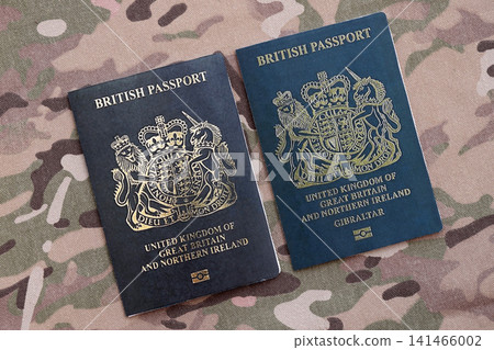British and Gibraltar passports on table. Official identification document books for citizens of UK 141466002