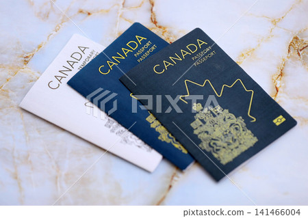 Canadian passports on table close up. Official identification document books for citizens of Canada 141466004