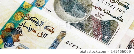 Algerian dinar paper banknotes pile on table. Algeria DZD currency money bills in big amount Algerian dinar paper banknotes pile on table. Algeria DZD currency money bills in big amount 141466009