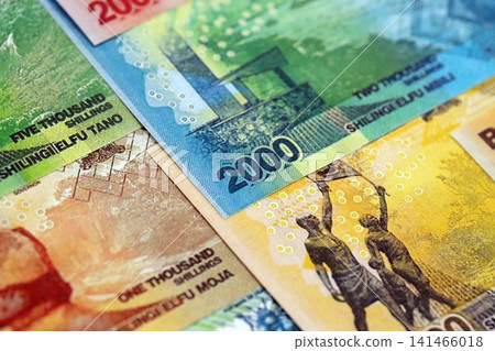 Ugandan shilling paper banknotes pile on table. Uganda UGX currency money bills in big amount 141466018