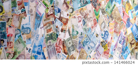 Different colorful banknotes from many various currencies of the world. Big stack of money bills Different colorful banknotes from many various currencies of the world. Big stack of money bills 141466024