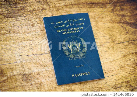 Afghan passport on table. Official identification document book for citizens of Afghanistan Afghan passport on table. Official identification document book for citizens of Afghanistan 141466030