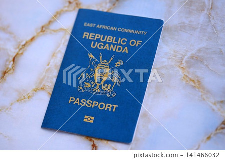 Ugandan passport on table close up. Official identification document book for citizens of Uganda Ugandan passport on table close up. Official identification document book for citizens of Uganda 141466032