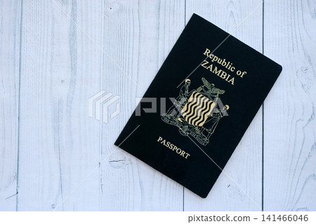 Zambian passport on table close up. Official identification document book for citizens of Zambia Zambian passport on table close up. Official identification document book for citizens of Zambia 141466046