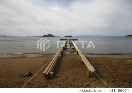old, rusty abandoned and dismantled pier. sky space is empty. suitable for writing. Seaside town of Turgutreis and spectacular sunshine. Long Exposure shoot. tranquility scene. old, rusty abandoned and dismantled pier. sky space is empty. suitable for writing. Seaside town of Turgutreis and spectacular sunshine. Long Exposure shoot. tranquility scene. 141466074