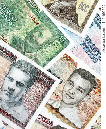 Cuban peso money bills pile on table. Cuba banknotes of CUP currency close up. Concept of business Cuban peso money bills pile on table. Cuba banknotes of CUP currency close up. Concept of business 141466262