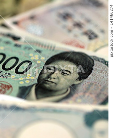 Japanese yen money bills pile on table. Japan banknotes of JPY currency. Concept of business Japanese yen money bills pile on table. Japan banknotes of JPY currency. Concept of business 141466274