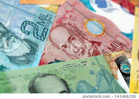 Costa Rican new colon money bills pile on table. Costa Rica banknotes of CRC currency close up Costa Rican new colon money bills pile on table. Costa Rica banknotes of CRC currency close up 141466288