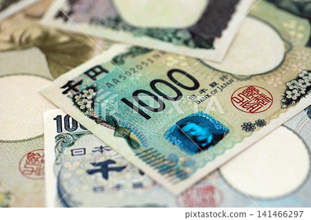 Japanese yen money bills pile on table. Japan banknotes of JPY currency close up Japanese yen money bills pile on table. Japan banknotes of JPY currency close up 141466297