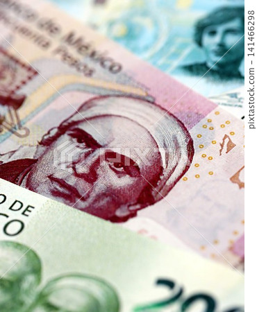 Mexican peso money bills pile on table. Mexico banknotes of MXN currency. Concept of business Mexican peso money bills pile on table. Mexico banknotes of MXN currency. Concept of business 141466298