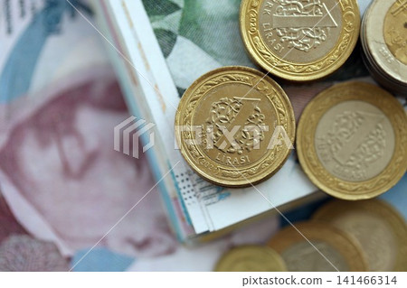 Turkish lira money bills and kurus coins pile on table. Turkey coins on banknotes of TRY currency Turkish lira money bills and kurus coins pile on table. Turkey coins on banknotes of TRY currency 141466314