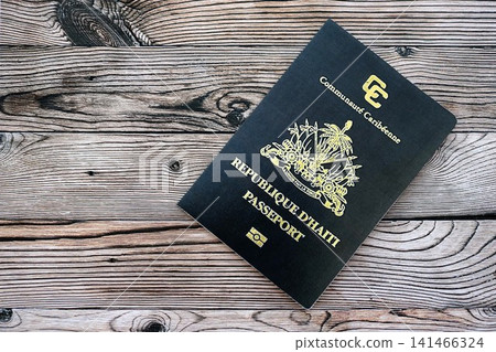 Haitian passport on table close up. Official identification document book for citizens of Haiti Haitian passport on table close up. Official identification document book for citizens of Haiti 141466324