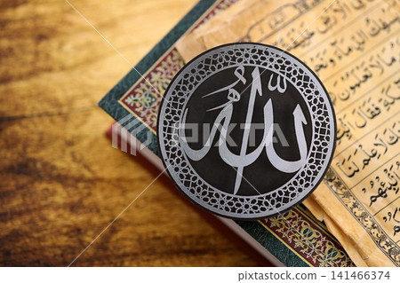 Sign with Islam inscription on Muslim holy book in mosque. Details of arabic calligraphy on sticker Sign with Islam inscription on Muslim holy book in mosque. Details of arabic calligraphy on sticker 141466374