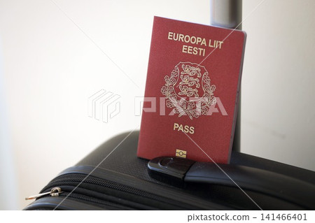 Estonia passport on touristic baggage luggage in airport. Travel and tourism in Europe concept Estonia passport on touristic baggage luggage in airport. Travel and tourism in Europe concept 141466401