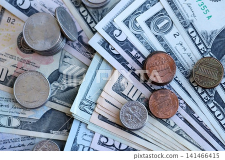 Half Dollar and one dollar coins on top of USD banknotes. Coins and paper money Half Dollar and one dollar coins on top of USD banknotes. Coins and paper money 141466415