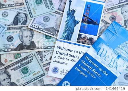 Permanent resident green card holders guide for new immigrants lies on many dollar bills Permanent resident green card holders guide for new immigrants lies on many dollar bills 141466419