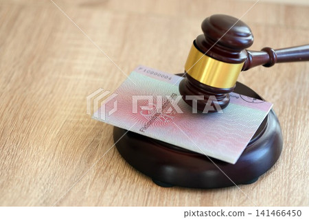German temporary Permanent resident card specimen lies with judge hammer. Fiktionsbescheinigung German temporary Permanent resident card specimen lies with judge hammer. Fiktionsbescheinigung 141466450