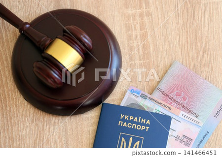 German temporary Permanent resident card and Ukrainian passport lies with judge hammer German temporary Permanent resident card and Ukrainian passport lies with judge hammer 141466451
