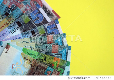 Kuwaiti dinar money bills in big amount on yellow. Finance and banking concept Kuwaiti dinar money bills in big amount on yellow. Finance and banking concept 141466458