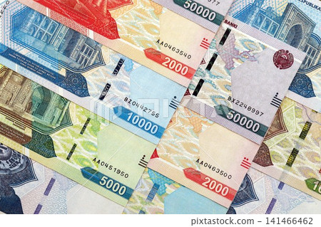 Uzbek som money bills pile on table. Uzbekistan banknotes of UZN currency close up Uzbek som money bills pile on table. Uzbekistan banknotes of UZN currency close up 141466462