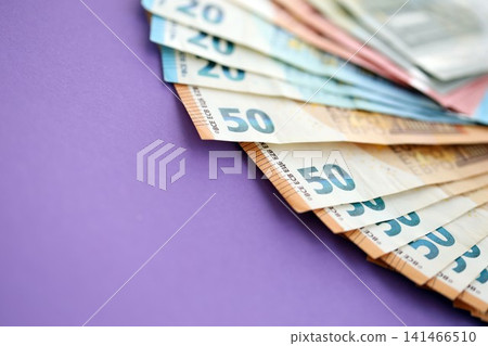 Big amount of european euro currency money notes on purple color table close up Big amount of european euro currency money notes on purple color table close up 141466510