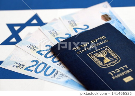 Israel New Shekels banknotes and passport on flag. The current Israel money bills and pass 141466525