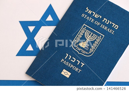 Israel passport on flag. The current Israel biometrical pass lies on flag close up 141466526