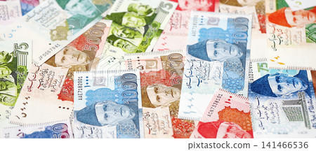 Pakistan rupees banknotes. The current Pakistan money bills lies on table in big amount Pakistan rupees banknotes. The current Pakistan money bills lies on table in big amount 141466536
