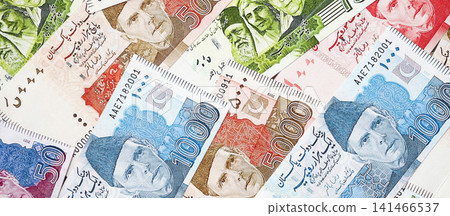 Pakistan rupees banknotes. The current Pakistan money bills lies on table in big amount Pakistan rupees banknotes. The current Pakistan money bills lies on table in big amount 141466537