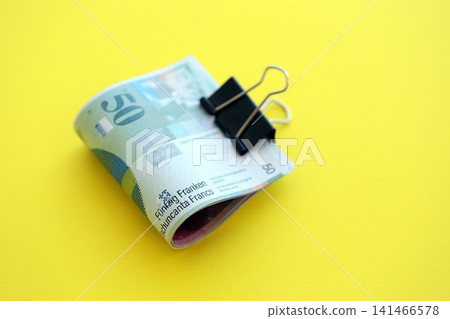 Swiss franc banknotes on yellow background. The current francs money bills lies in big amount Swiss franc banknotes on yellow background. The current francs money bills lies in big amount 141466578