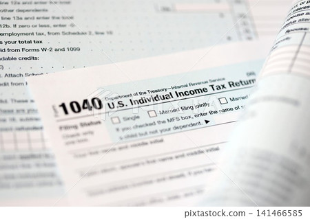 1040 US individual income tax return form blank close up. Few pages of united states tax blank 1040 US individual income tax return form blank close up. Few pages of united states tax blank 141466585