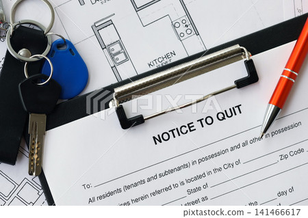 Pen and keys on Notice to quit form and planning blueprints of residential building project close up Pen and keys on Notice to quit form and planning blueprints of residential building project close up 141466617