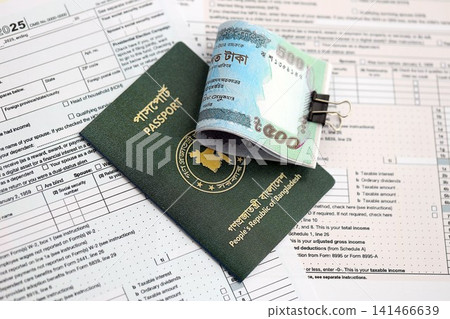 Bangladeshi taka money bills in big amount lies on table with passport and tax forms close up Bangladeshi taka money bills in big amount lies on table with passport and tax forms close up 141466639