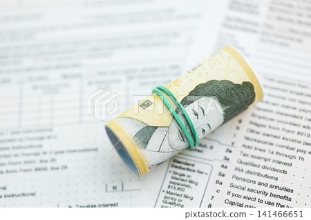 South Korean won money bills in big amount lies on table with tax forms close up South Korean won money bills in big amount lies on table with tax forms close up 141466651