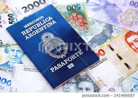 Argentine passport lies on Argentina pesos money bills close up. Travel and citizenship Argentine passport lies on Argentina pesos money bills close up. Travel and citizenship 141466687