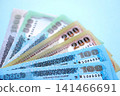 Bangladeshi taka money bills in big amount lies on teal color table close up 141466691