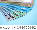 Bangladeshi taka money bills in big amount lies on teal color table close up 141466692