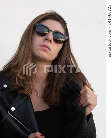 Young woman with sunglasses creating rebellious fashion style Young woman with sunglasses creating rebellious fashion style 141466728