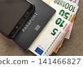 Modern black cellphone, Euro money banknotes bills and travel passport on copy space background. Travelling light, comfortable journey concept. 141466827