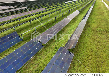 Large-scale solar photovoltaic power station producing clean and sustainable electricity without harmful emissions. Example of modern green energy infrastructure Large-scale solar photovoltaic power station producing clean and sustainable electricity without harmful emissions. Example of modern green energy infrastructure 141466866