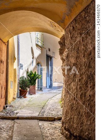 Cervo, liguria, italy. June 22, 2025. Cervo, liguria, italy. Cobblestone alley creating a tunnel with a stone archway, leading to another ancient street Cervo, liguria, italy. June 22, 2025. Cervo, liguria, italy. Cobblestone alley creating a tunnel with a stone archway, leading to another ancient street 141466870