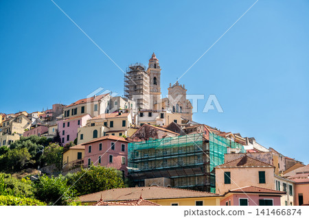 Cervo, liguria, italy. June 22, 2025. Cervo village on a hillside in liguria, italy, showing historic architecture and a church undergoing renovation Cervo, liguria, italy. June 22, 2025. Cervo village on a hillside in liguria, italy, showing historic architecture and a church undergoing renovation 141466874