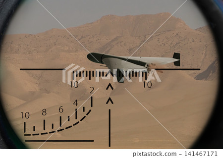 Kamikaze drone in military optical sight over desert mountain landscape Kamikaze drone in military optical sight over desert mountain landscape 141467171