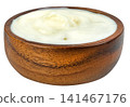 Fresh thick white Greek yogurt or sour cream in a rustic round wooden bowl isolated. Creamy texture ideal for healthy breakfast, cooking, and dairy product concepts. 141467176