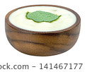 Organic white yogurt in a rustic wooden bowl topped with green spirulina or matcha powder. Healthy breakfast superfood concept isolated for nutrition and wellness marketing. 141467177