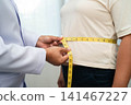 Asian woman with fat belly big size overweight and obesity with measure tape. 141467227