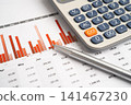 Calculator with pen on data business graphs paper. 141467230