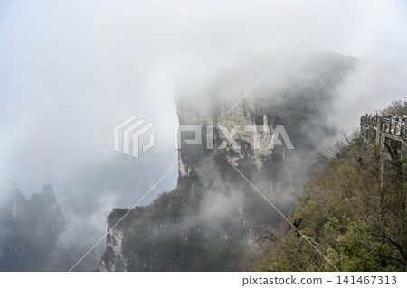 View of the Tianmenshan Mountains in the fog near Zhangjiajie in China View of the Tianmenshan Mountains in the fog near Zhangjiajie in China 141467313