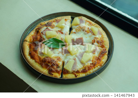 closeup Hawaiian pizza with pineapple and bacon, garnished with vegetables, served on a metal cement floor background, food, hot, italian, copy space closeup Hawaiian pizza with pineapple and bacon, garnished with vegetables, served on a metal cement floor background, food, hot, italian, copy space 141467943